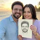 Carlos M. and his partner holding a hand-drawn Eva Bloom Soulmate Sketch portrait on a beach at sunset